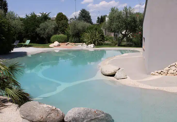 mimimal concrete_685 a Biodesign pool surrounded by natural vegetation